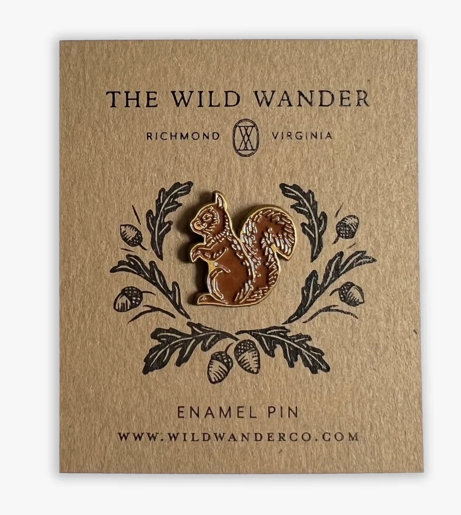 Brown squirrel enamel pin on tan card with oak leaves, acorns; The Wild Wander Richmond VA branding, wildlife gift accessory.