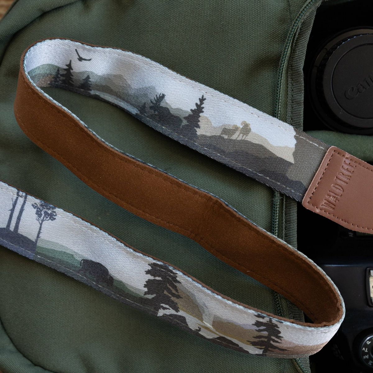 Forager Provisions LTD Wildtree Wildlife Wander camera strap with wilderness landscape print and brown faux suede backing