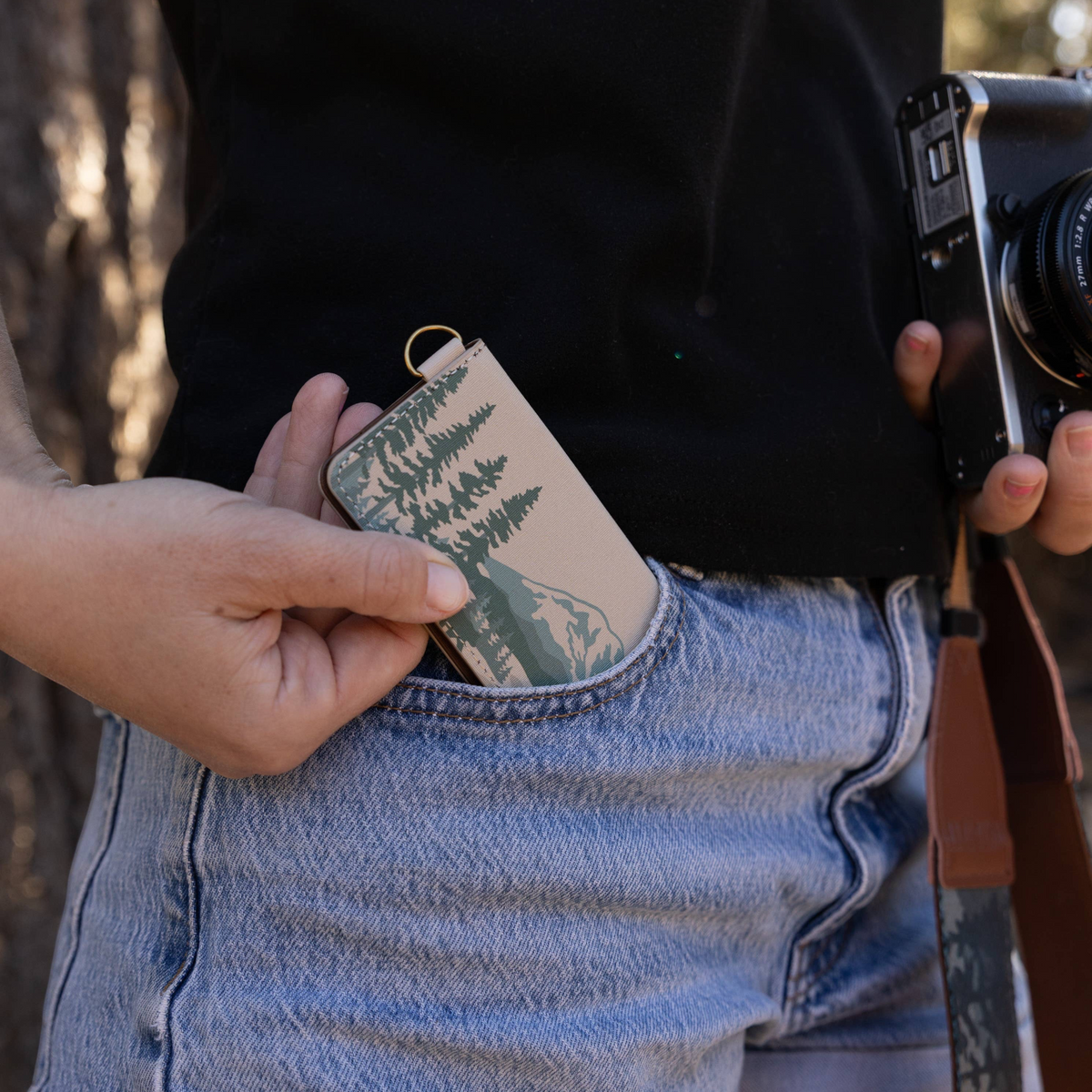 Forager Provisions LTD Wildtree National Parks card holder being placed into a denim pocket by a photographer