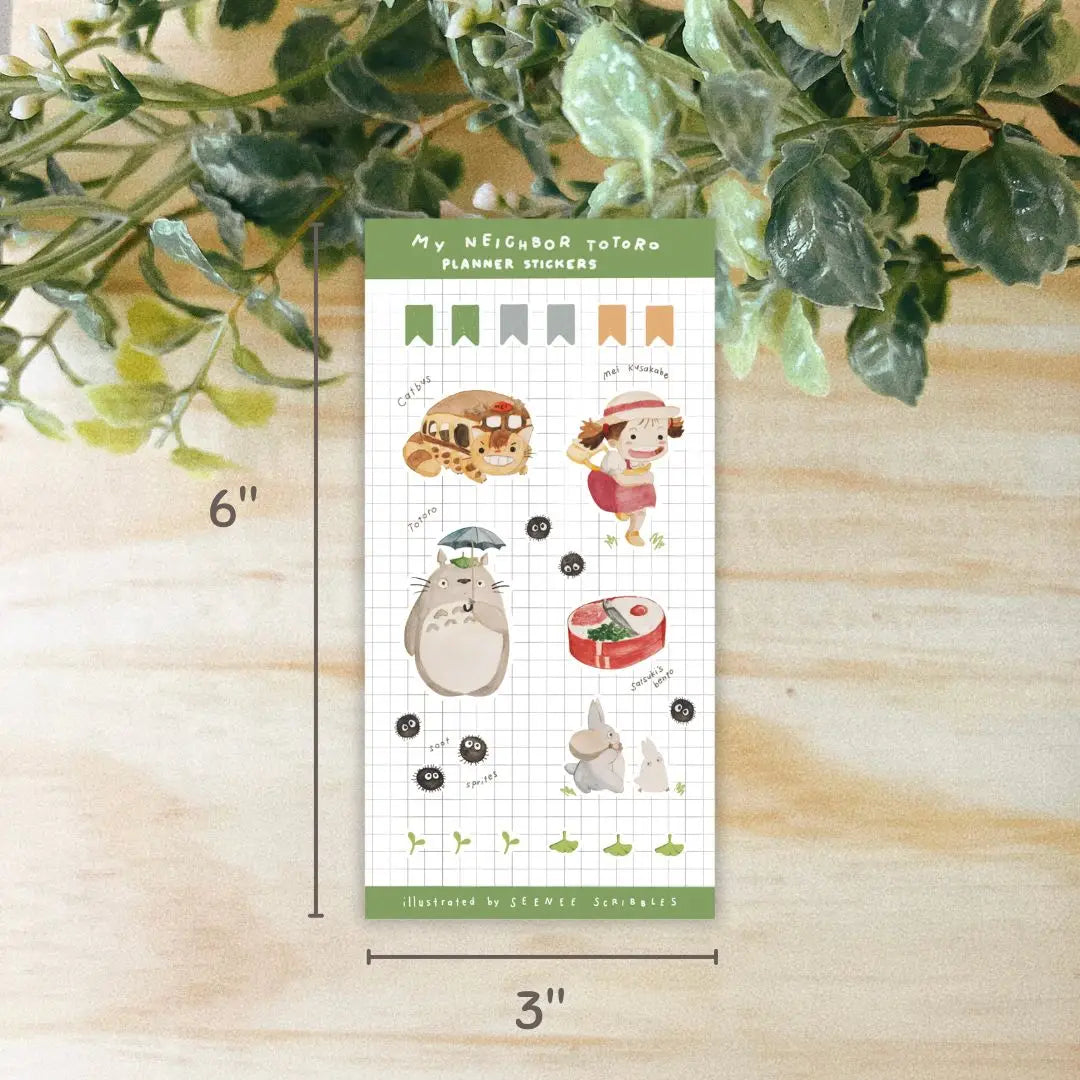The Seenee Scribbles Studio Ghibli Inspired Sticker Sheet - My Neighbour Totoro is perfect for bullet journaling and scrapbooking, showcasing beloved characters such as Totoro, Catbus, Soot Sprites, and more on a grid background. These stickers bring a touch of magic to your creative projects.