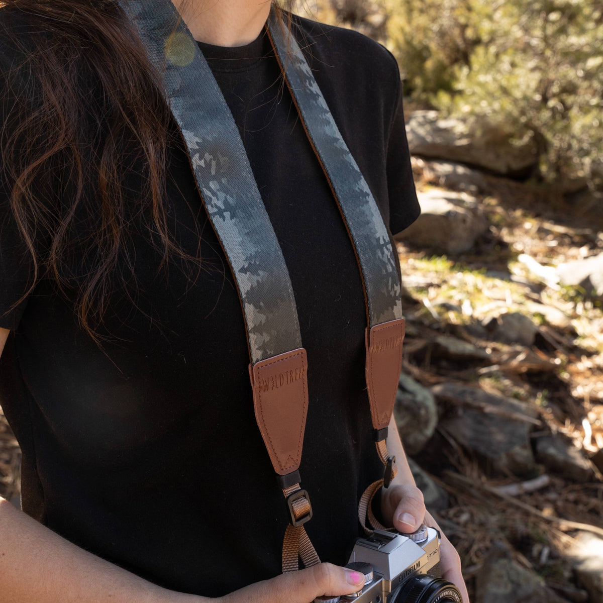 Forager Provisions LTD Wildtree Foggy Forest camera strap with mountain print and brown faux suede ends on a person
