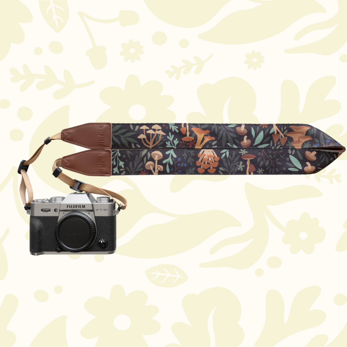 Forager Provisions LTD Wildtree Forest Foliage camera strap with mushroom print and brown faux suede backing on camera
