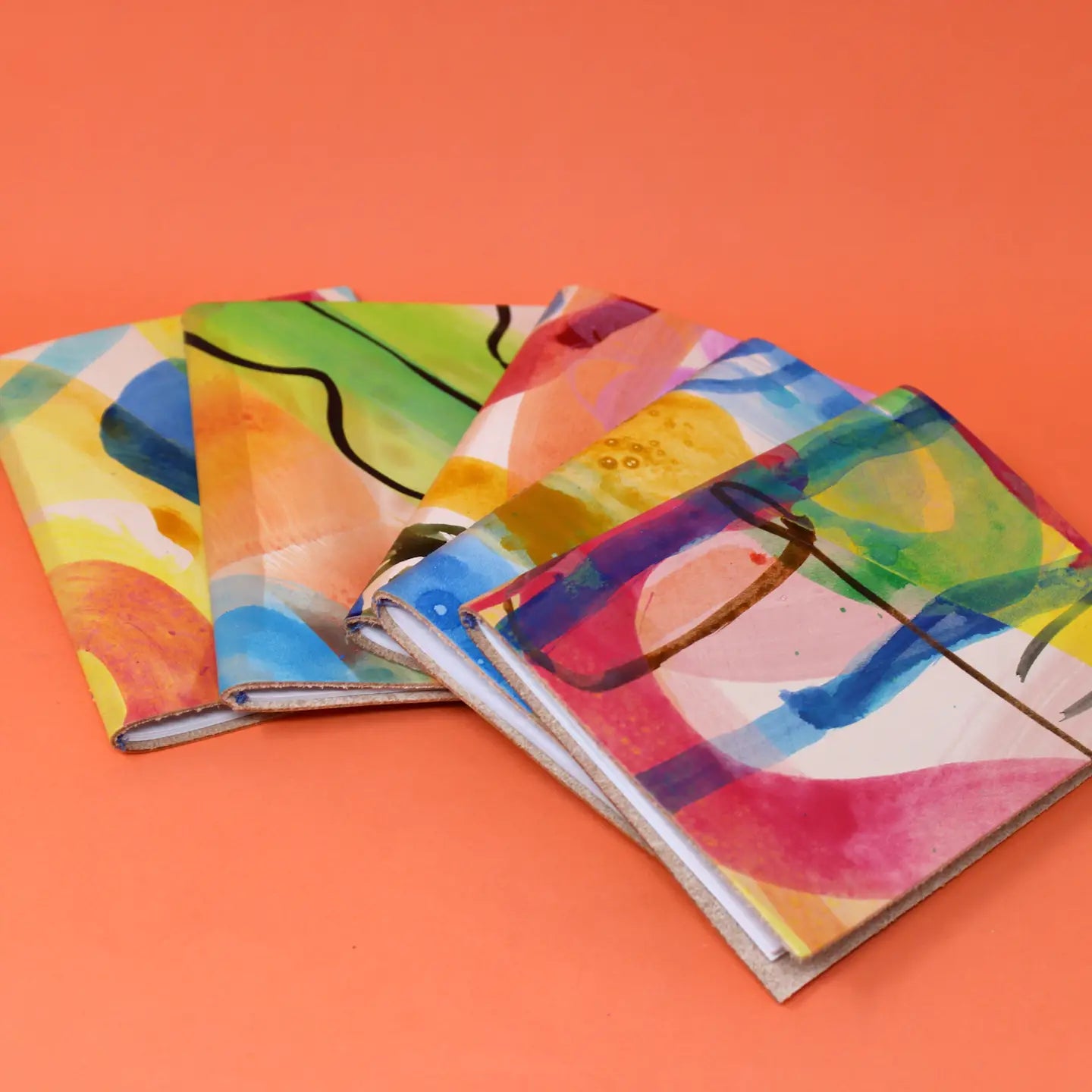 Ark Handpainted A6 Genuine Leather Sketchbook on orange background—perfect artist journal, luxury leather-bound sketch pad gift.