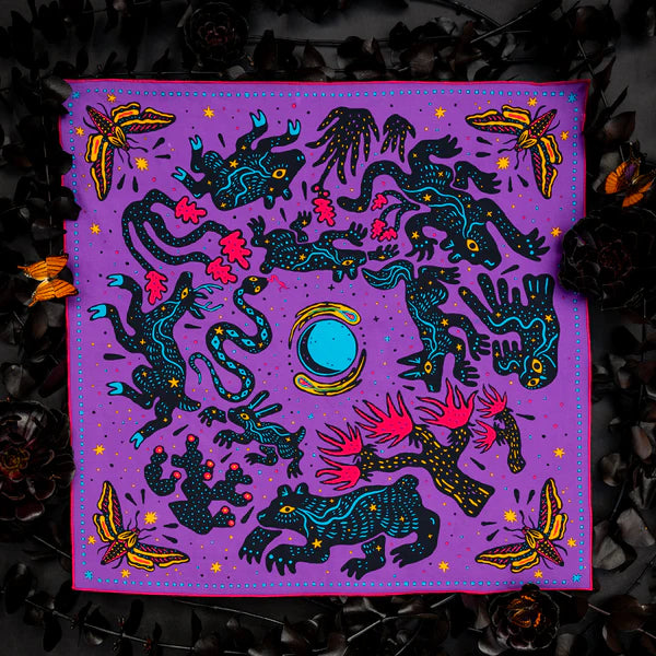 Handmade purple bandana Electric Desert Parade by Bandit Bandanas with animals, plants & bold blue center, artisan gift.