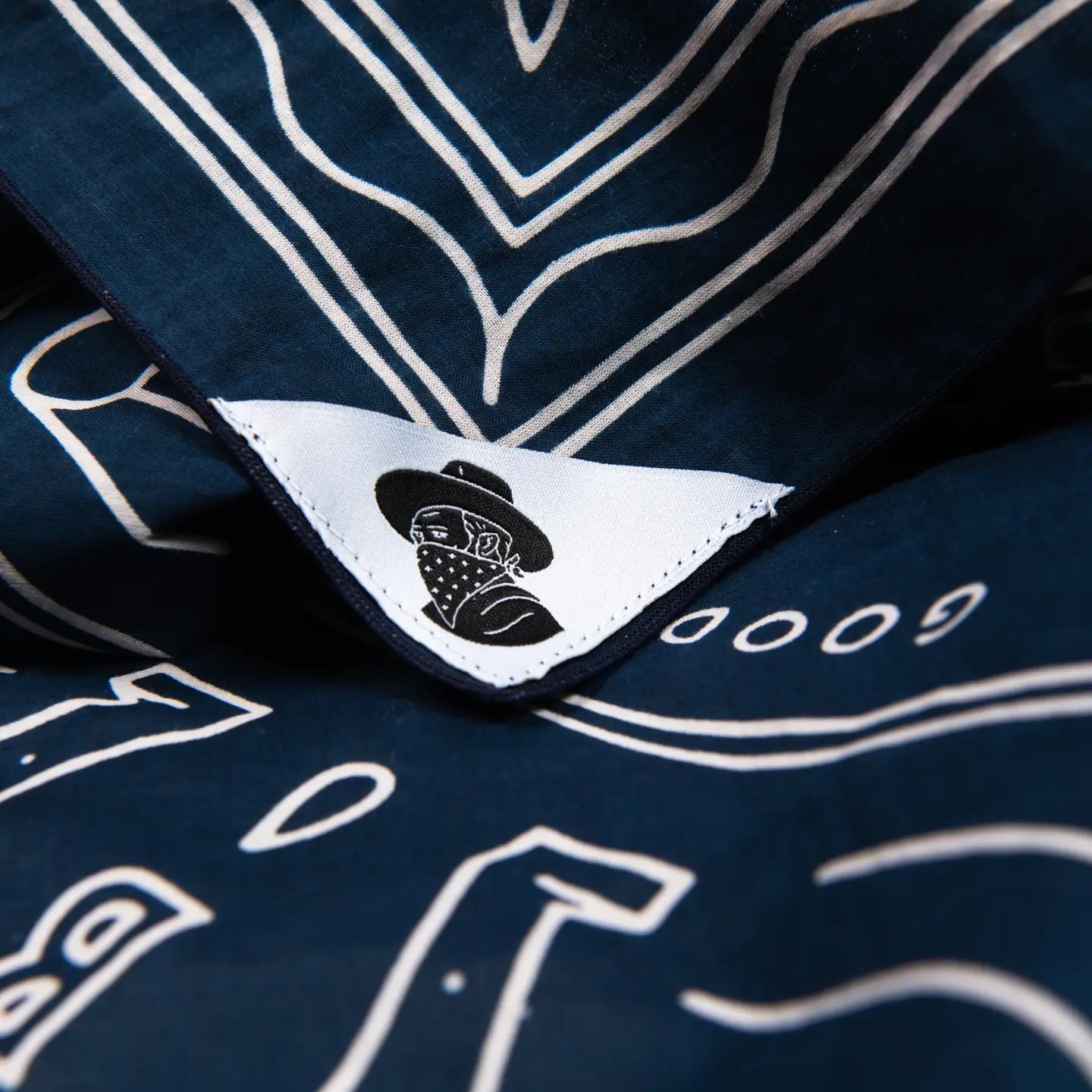 Navy “Good Luck” organic cotton bandana by Bandit Bandanas, vintage style, white details, logo tag. Cotton scarf accessory.
