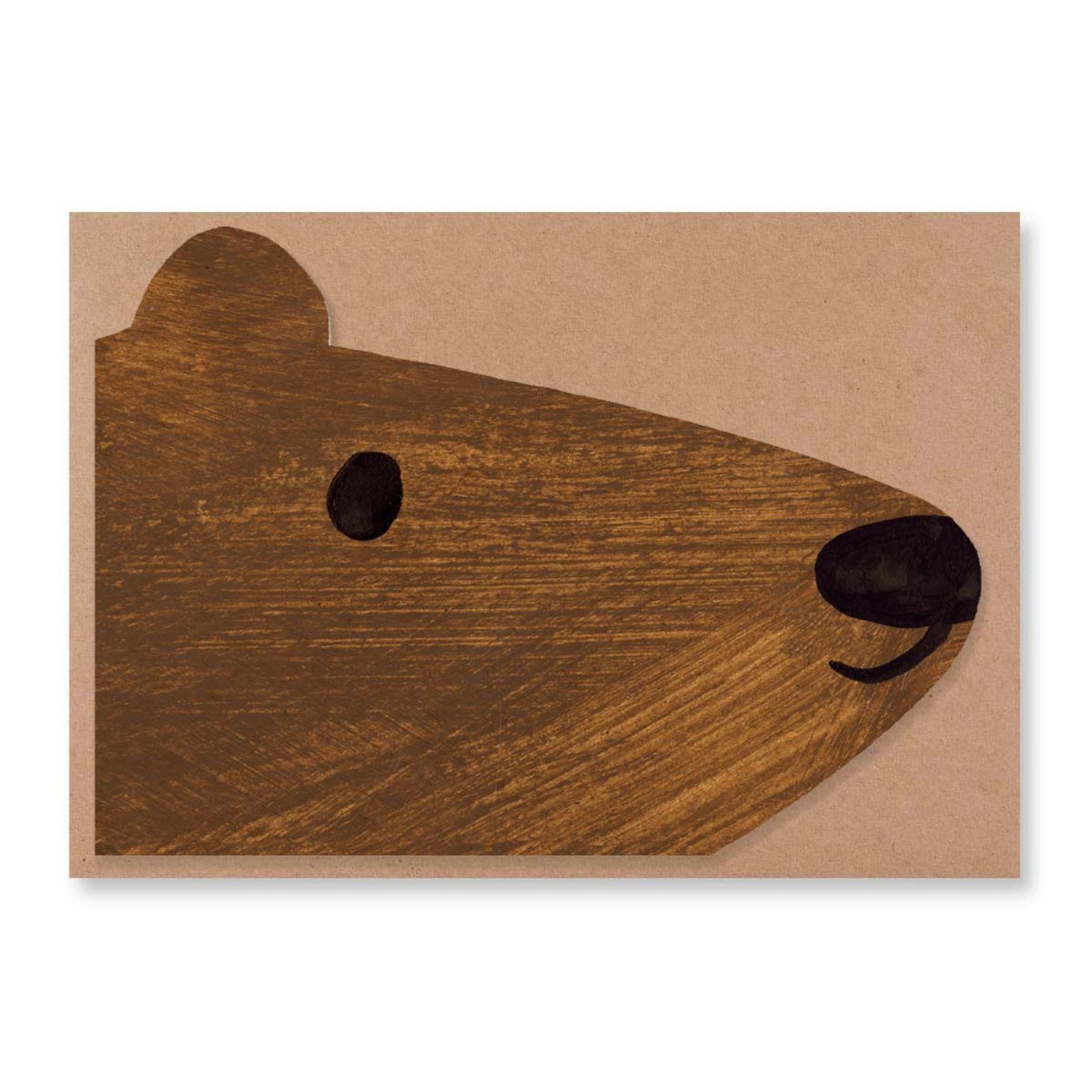 A face of a brown bear shaped card is laid on a brown envelope.