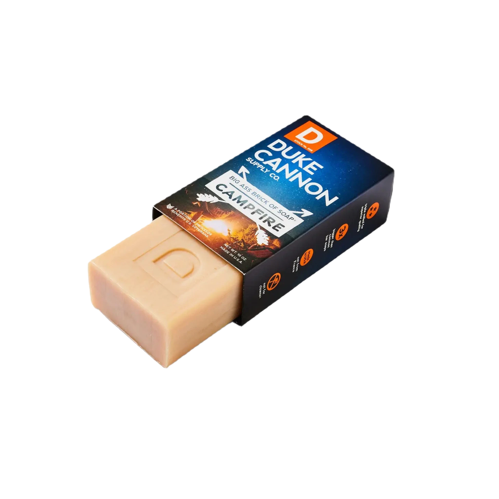 A large bar soap next to boxed packaging labeled "Duke Cannon Big Ass Brick Of Soap - Campfire," emitting a distinct smoky scent, proudly American-made.