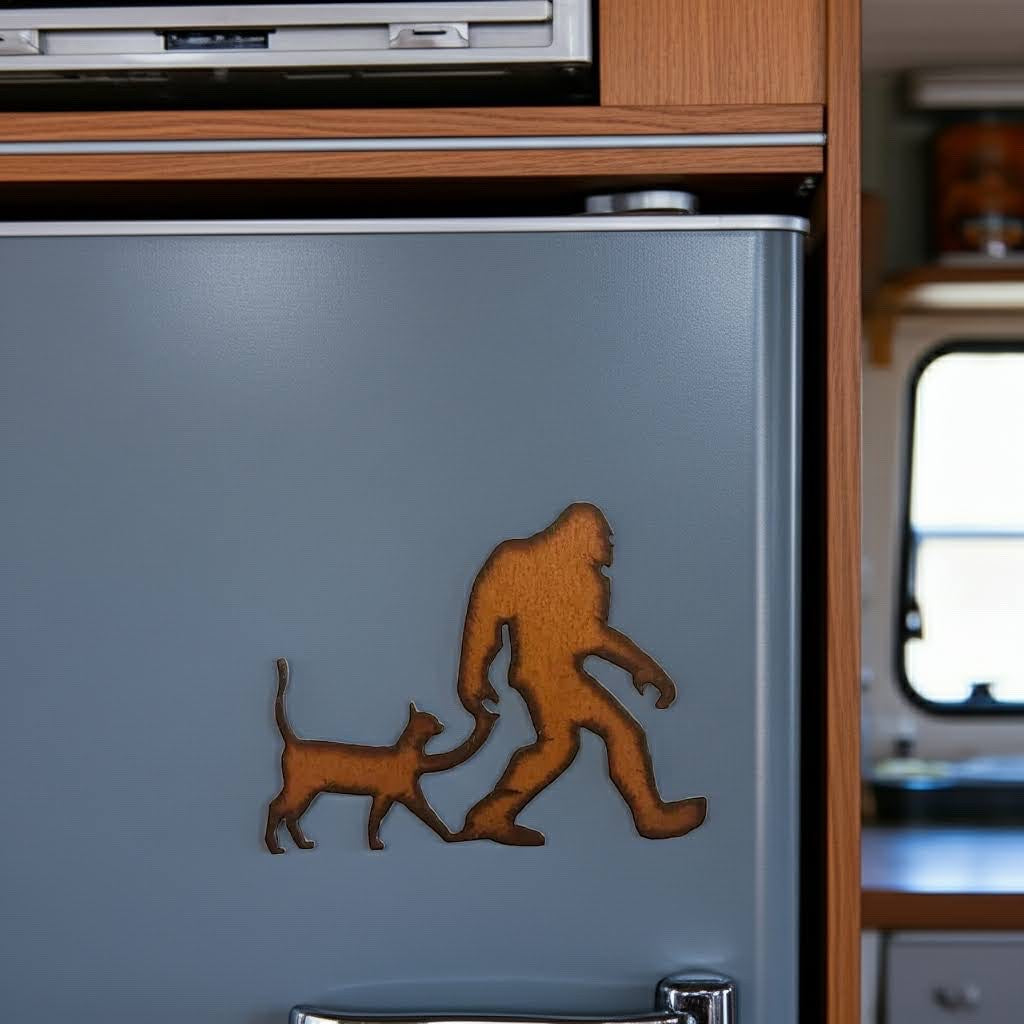 Forager Provisions LTD rustic steel Bigfoot with cat magnet attached to a grey refrigerator door