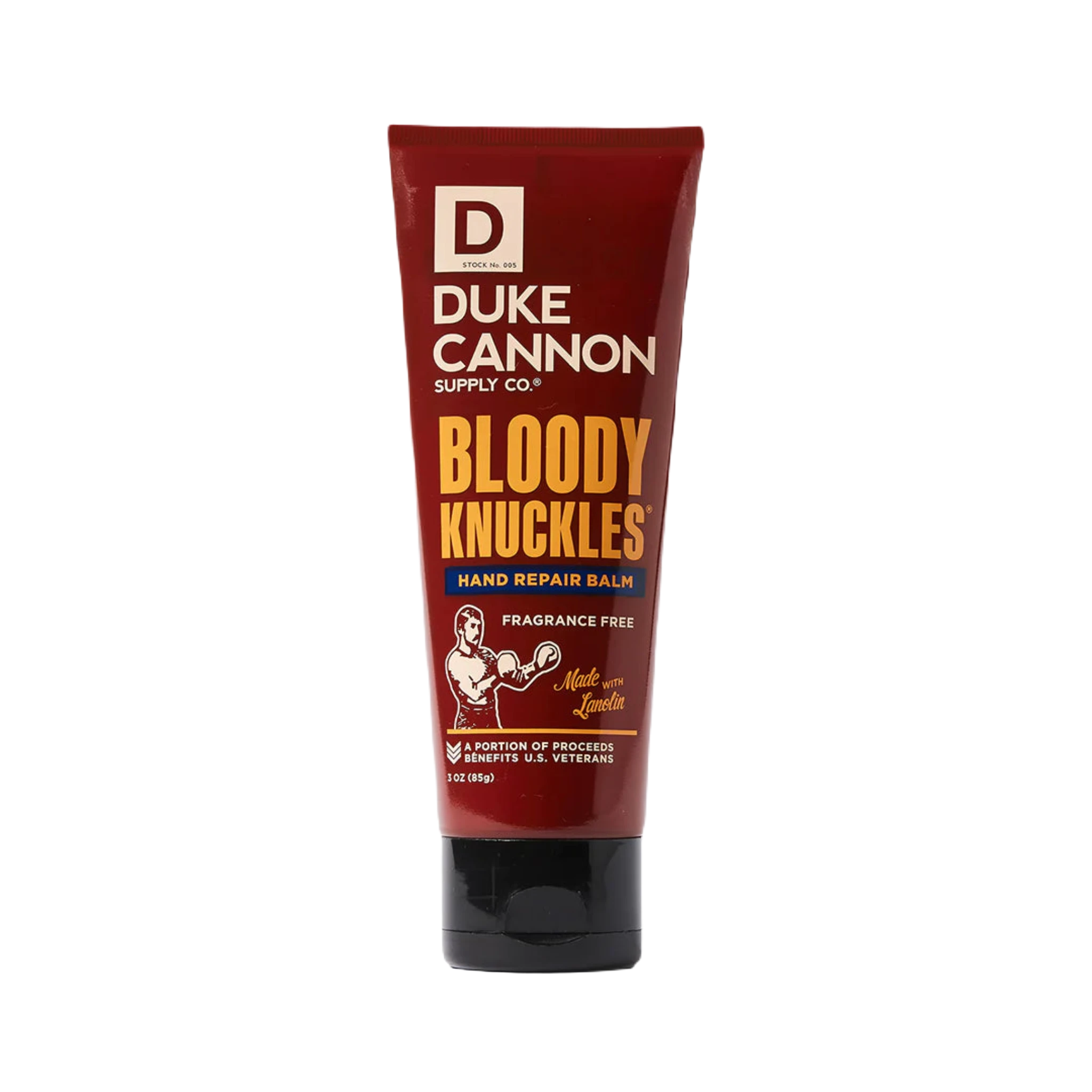 A red tube of Duke Cannon Bloody Knuckles Hand Repair Balm, labeled as fragrance-free and ideal for dry, cracked hands, with proceeds supporting U.S. veterans.