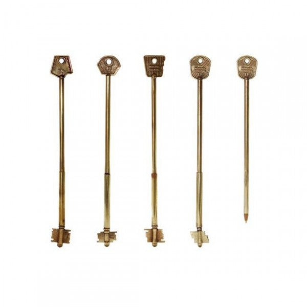 Brass key-shaped pen by Forager Provisions stands vertically on white background, unique vintage office stationery gift idea.