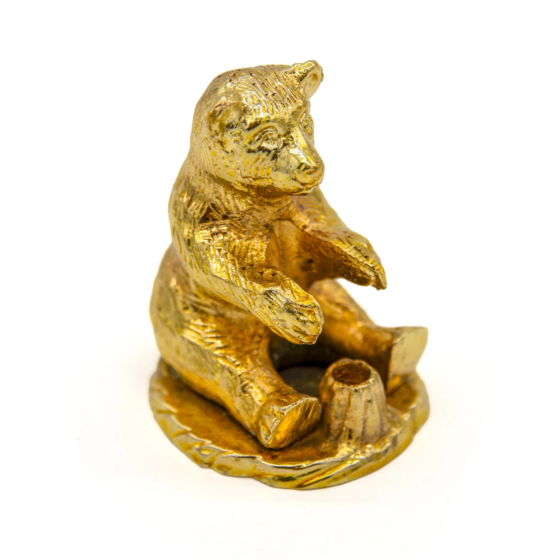 a brass coloured bear sitting down with arms stretched out with visible incense hole