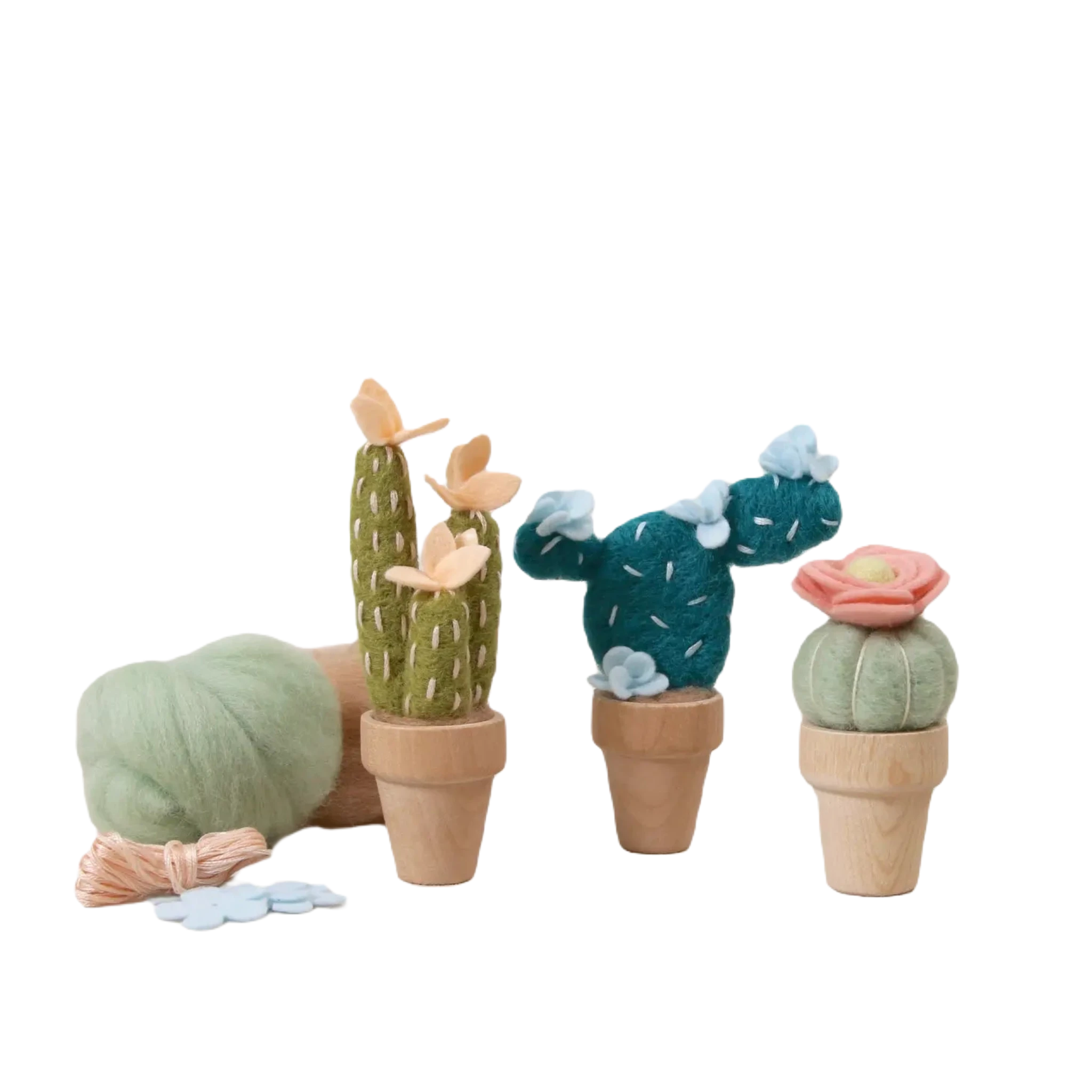 Three small potted felt cacti, featuring the charming Peach Mojave Cactus from the Benzie Design Felt DIY Kit, are each adorned with pastel-colored flowers. They are set against a light background along with needle felting kit supplies, making it a perfect DIY craft for both children and adults.
