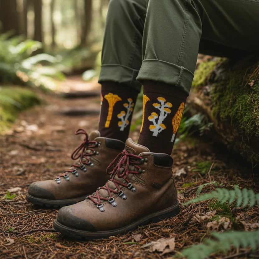 Camp Mustelid brown cotton socks feature autumn mushroom designs, colorful fungi, and whimsical "mushrooms growing out of your shoes!.
