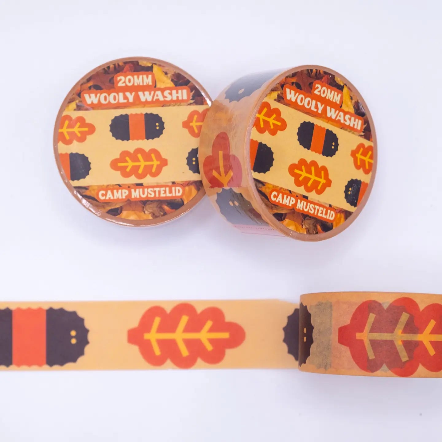 Two Camp Mustelid Wooly Washi Tapes with orange, black leaf, and caterpillar designs; ideal for crafts and decorating projects.