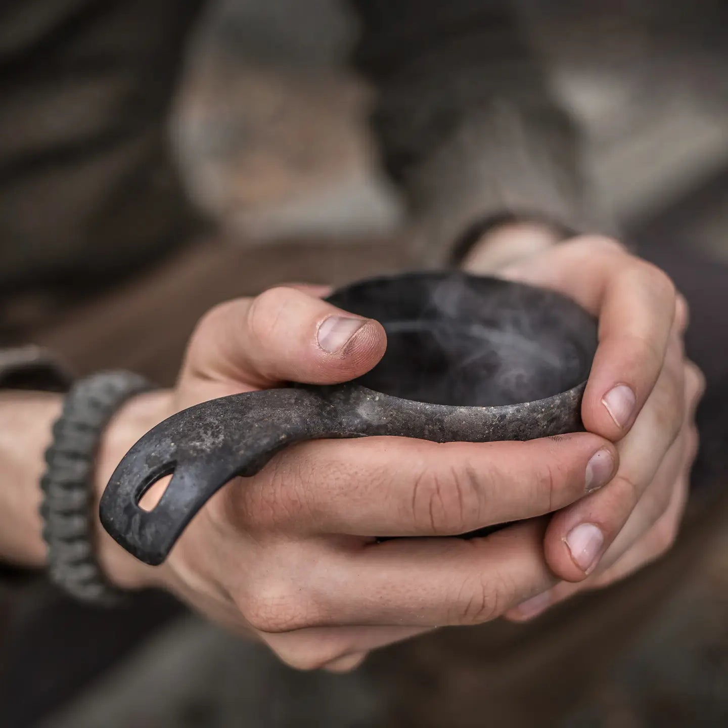Hand holding Kupilka 21 Classic Cup in Black, eco-friendly natural fibre mug, durable outdoor camping gear by Kupilka.