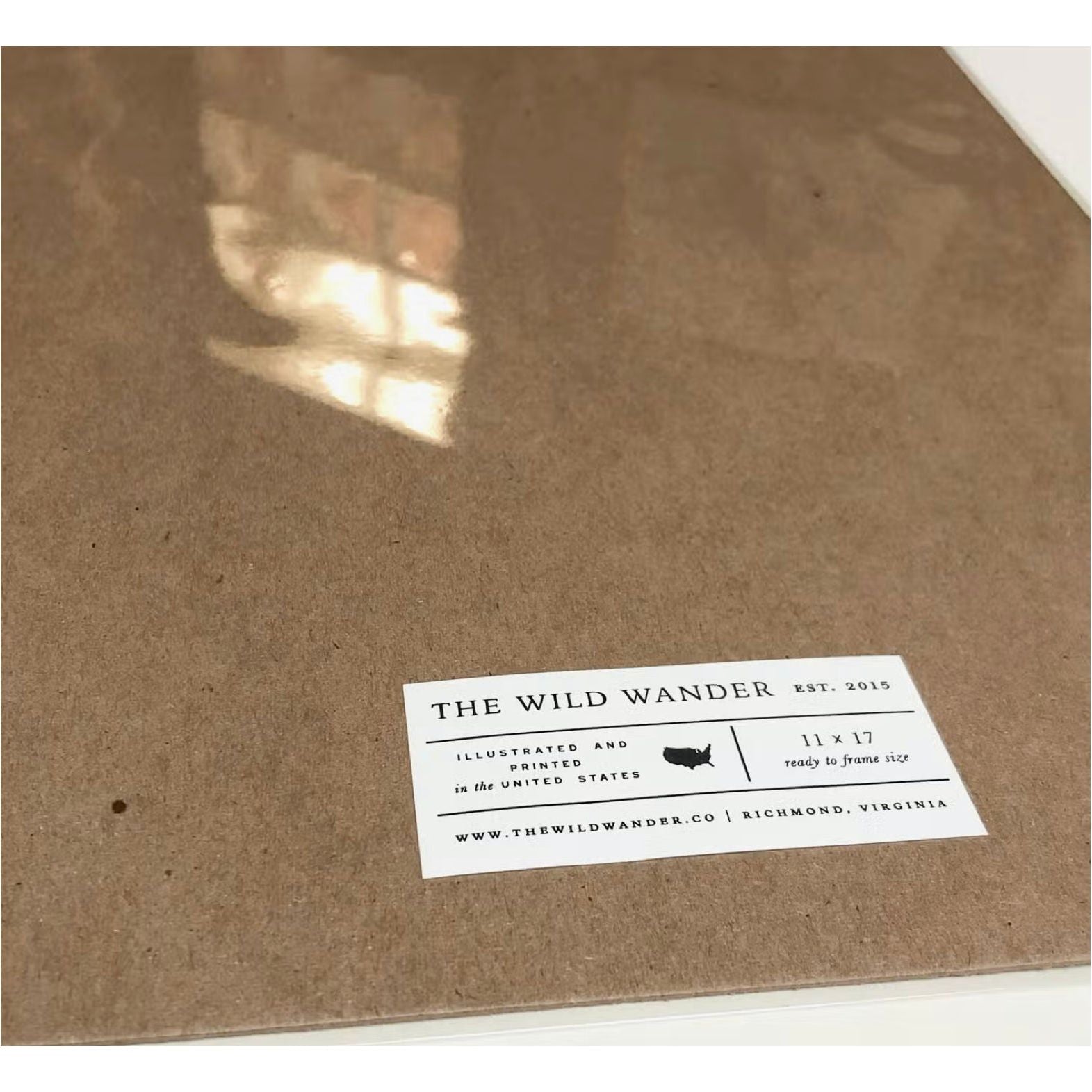Closeup of a brown cardboard package with "The Wild Wander" brand label indicating it's an 11x17 illustrated field guide print of Great Smoky Mountains National Park.