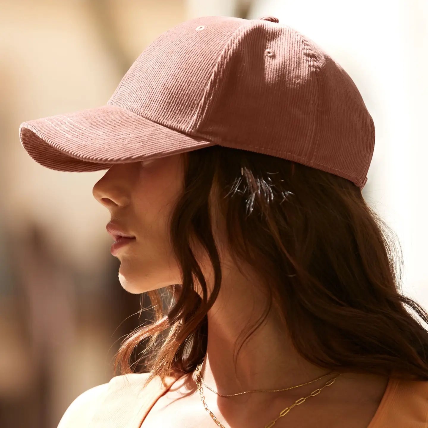 Side view of a person with long hair in a Redwood Forager Provisions Earthaware® Cord Baseball Cap stylish eco headwear.
