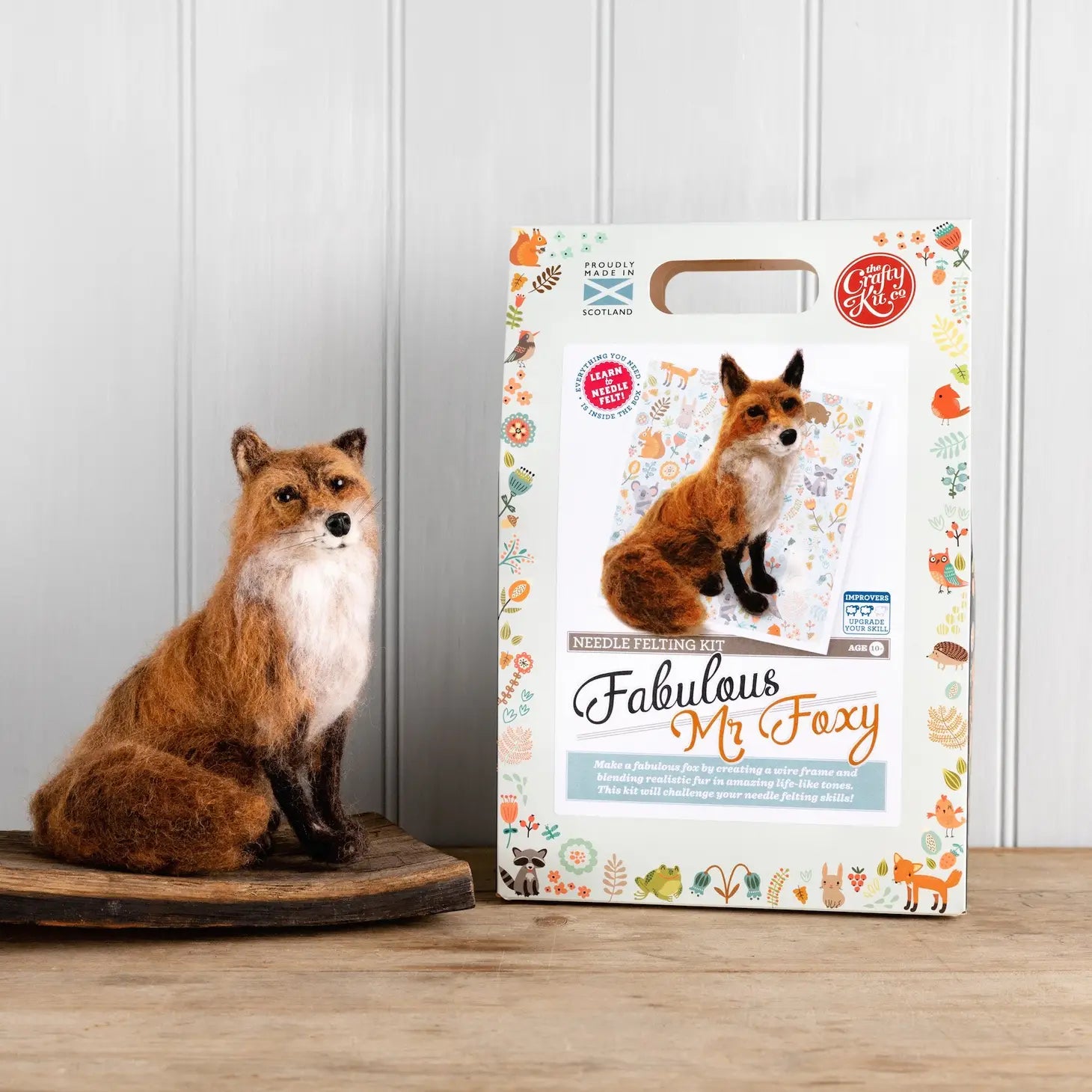 The Crafty Kit Company Fabulous Felt Foxy is a felted wool fox sculpture, crafted from Corriedale wool, featuring a bushy tail. It sits and looks forward on a white background, making it perfect for those who enjoy the Needle Felting Craft Kit experience. Meet Mr Foxy!