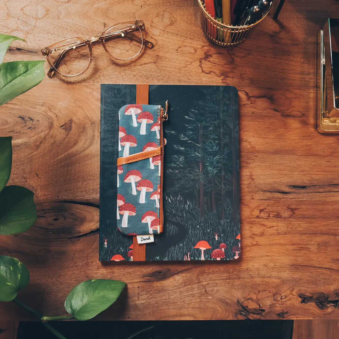 Denik Navy Mushroom Vegan Leather Notebook Pouch, notebook, and pen on a desk—stylish writing accessories workspace setup.