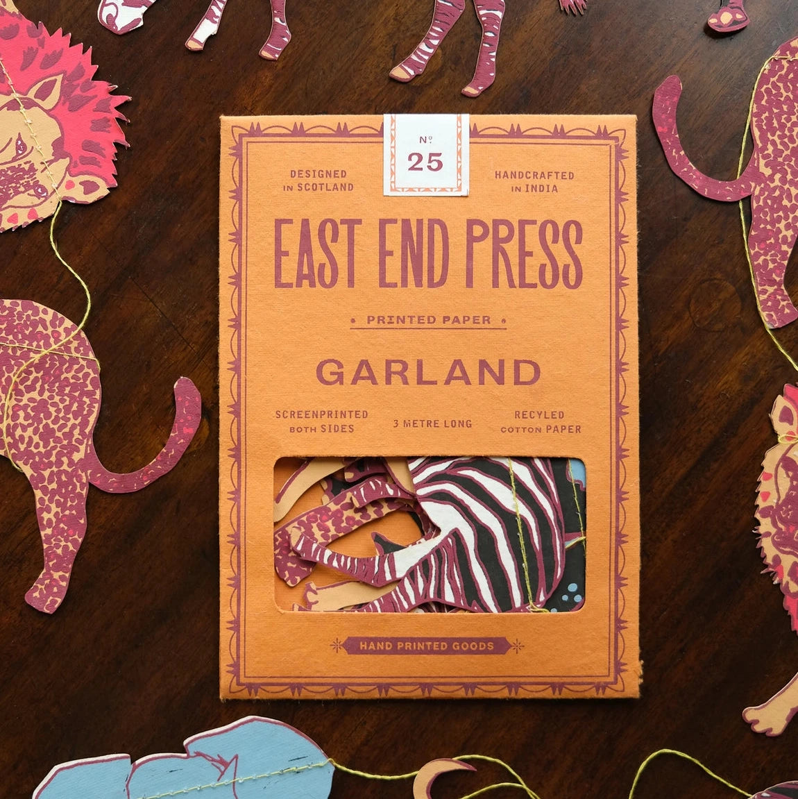 East End Press Safari Animals Sewn Garland in orange box, animal garlands displayed on wooden table, party decoration.