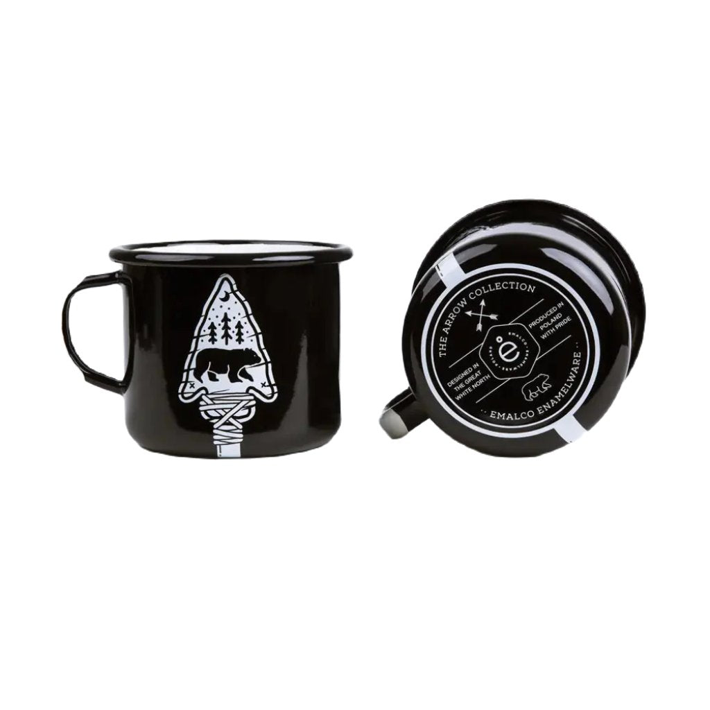 Two Emalco Enamelware 16.9oz Enamel Bear & Arrow Mugs: one upright showcasing a tree and campfire design, perfect for outdoor adventures; the other on its side displaying brand details and logo at the bottom, crafted from durable material to withstand rugged use.
