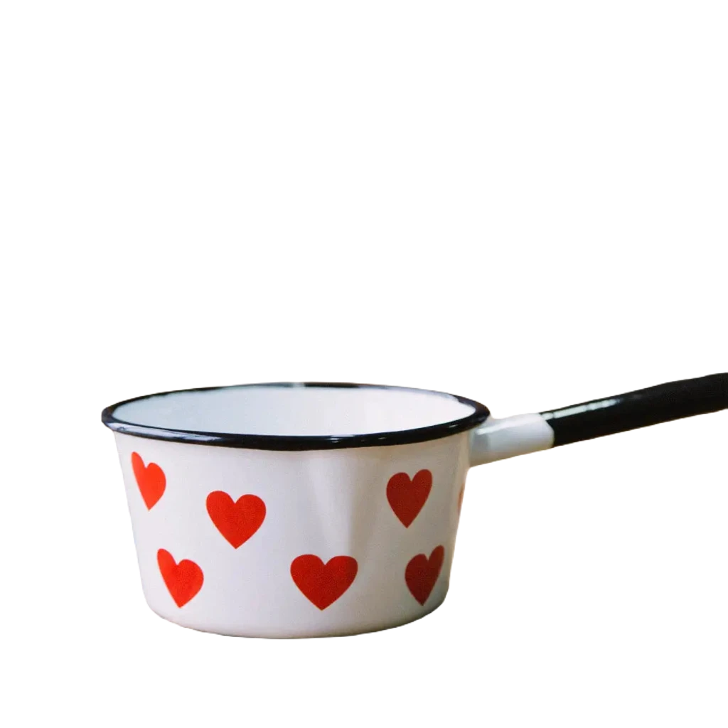 The Emalco Enamelware Enamel Heart Saucepan, featuring a white body with a black handle, is crafted from durable enamel material and adorned with charming red heart patterns. Pictured on a white background, it’s the perfect addition to your Emalco Enamelware collection.
