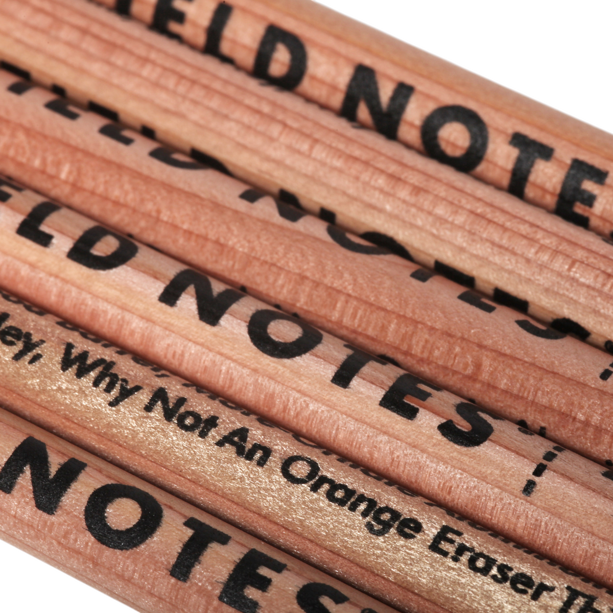 Field Notes Square Deal No. 2 Woodgrain Pencils 6 Pack, close-up of black branded pencils stacked neatly, woodgrain texture visible.