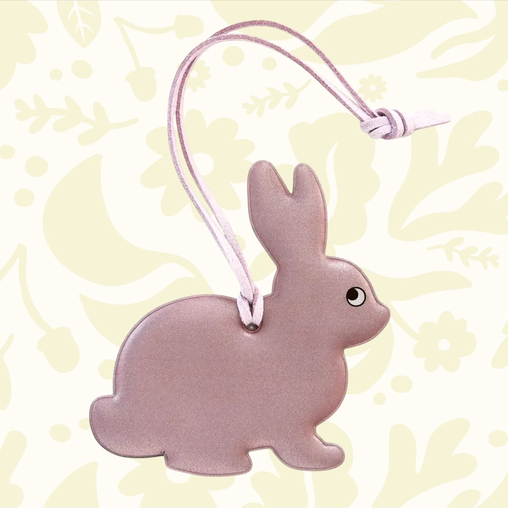 Firefly Sweden Pink Bunny Reflector Bag Charm—cute flat pink bunny tag with simple face, ideal bag accessory for safety and style.