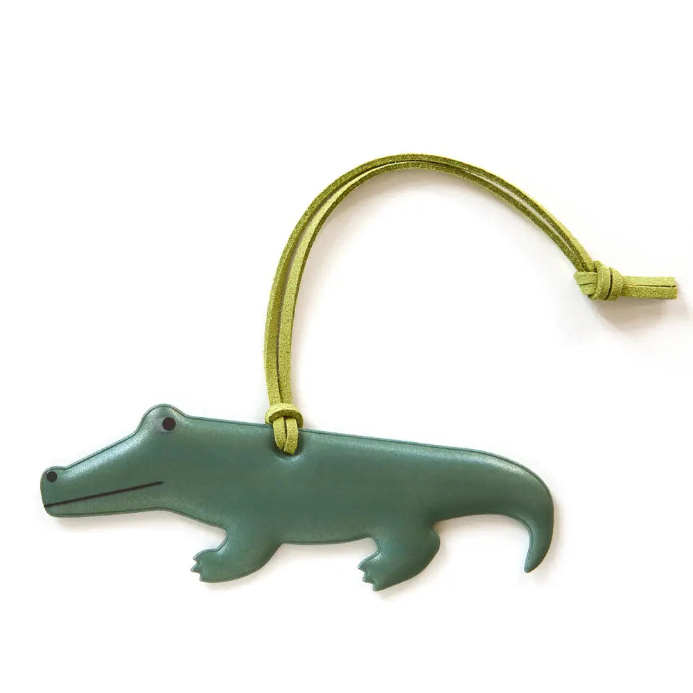 Firefly Sweden Crocodile Reflector Bag Charm—fun animal-shaped safety accessory with vibrant yellow-green strap for visibility.
