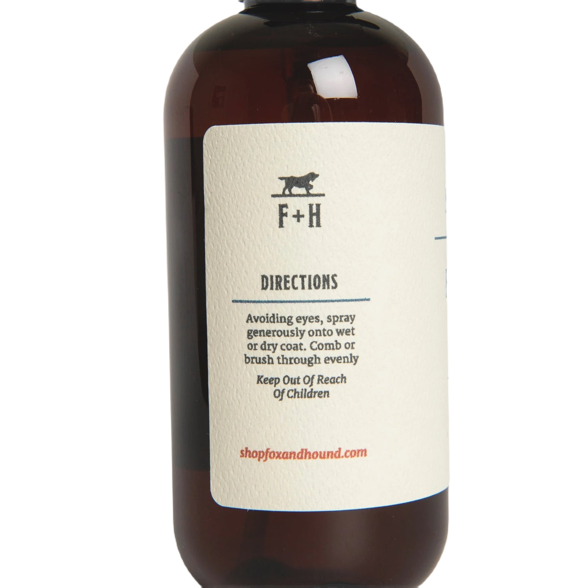 Against a plain white background, a brown bottle of Fox + Hound Dog Fragrance Spray, labeled "Redwood Amber," offers a long-lasting scent and serves as an effective pet odor solution.