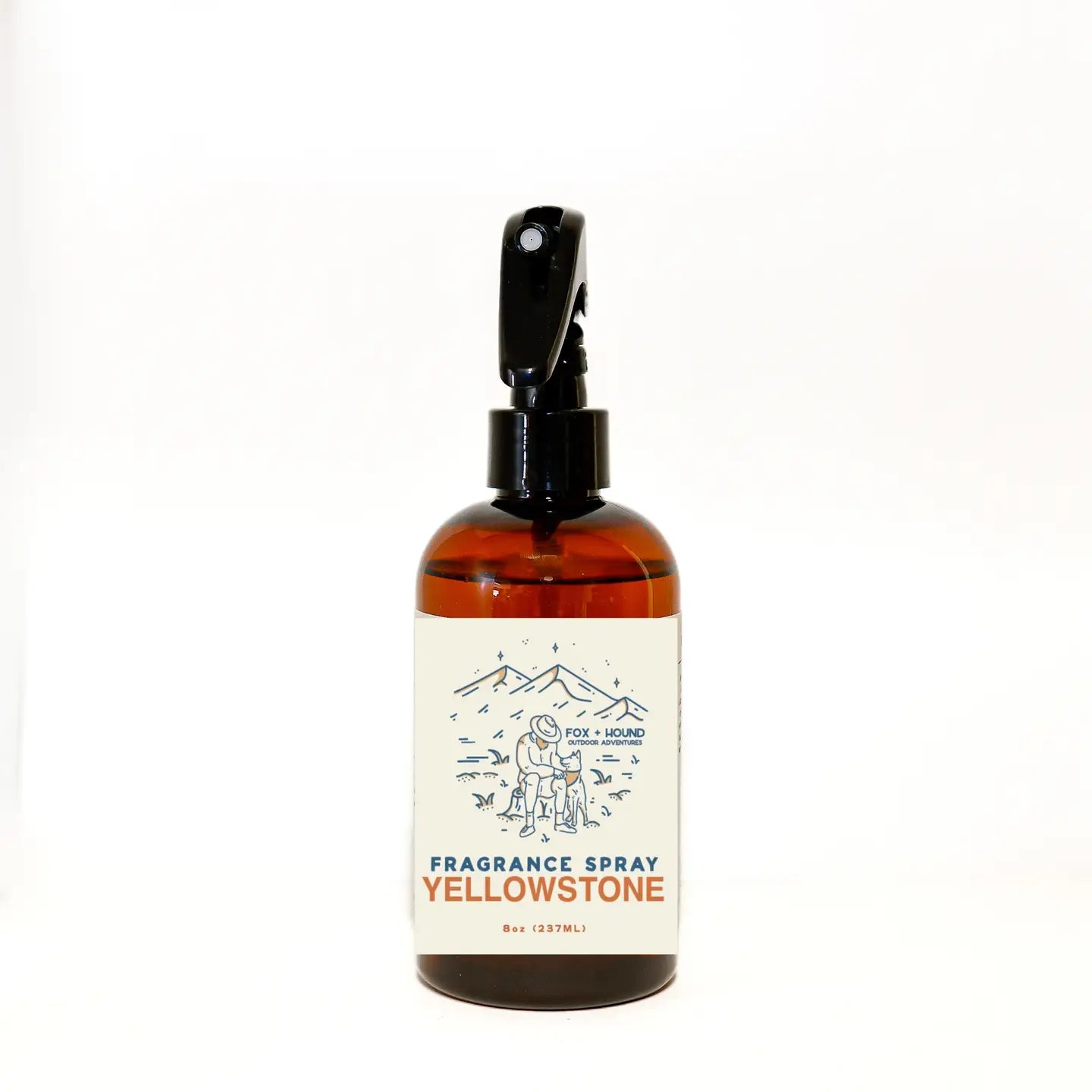 A brown bottle of Fox + Hound Dog Cologne - Yellowstone with a black sprayer and an illustration on the label, part of the Outdoor Adventures Collection.