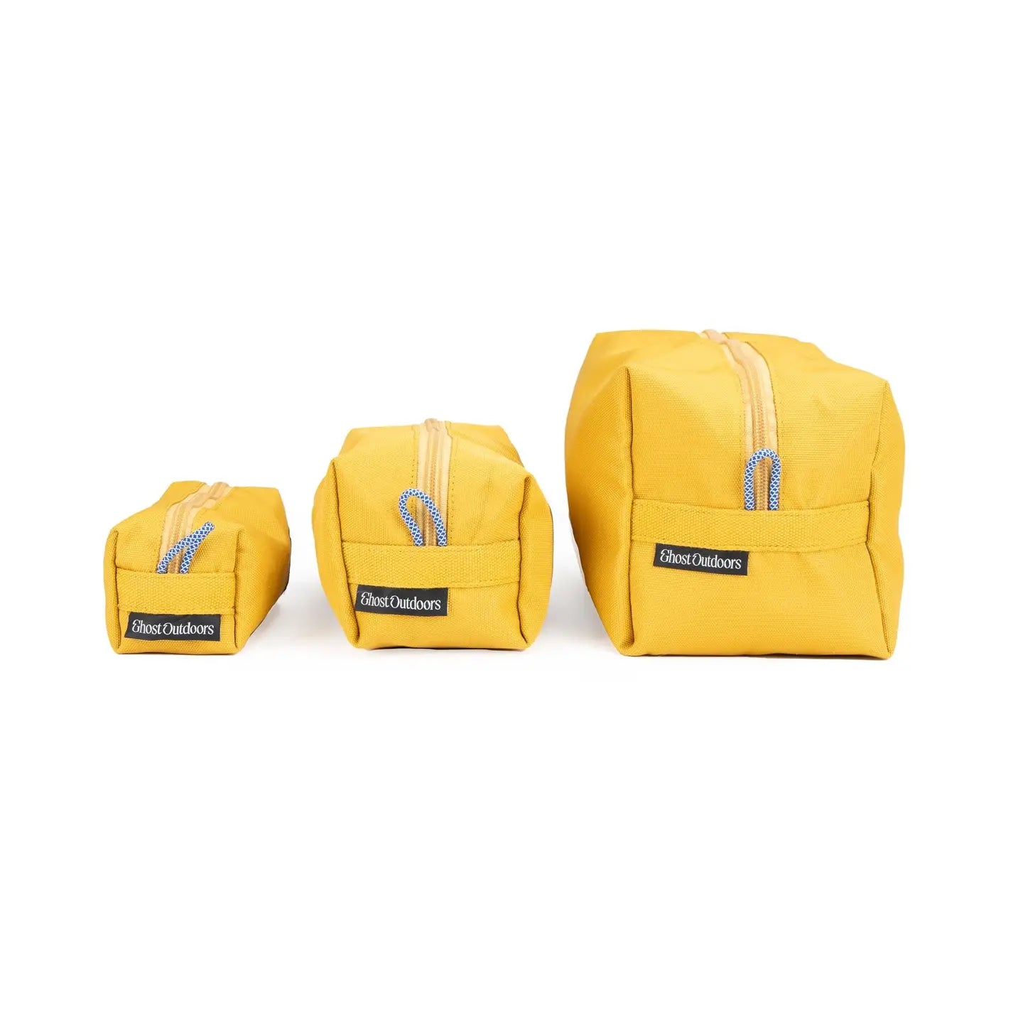 Ghost Outdoors Ochre Yellow Dopp Kit 3-Pack displayed in a row on a white background, stylish toiletry travel organizer bags.