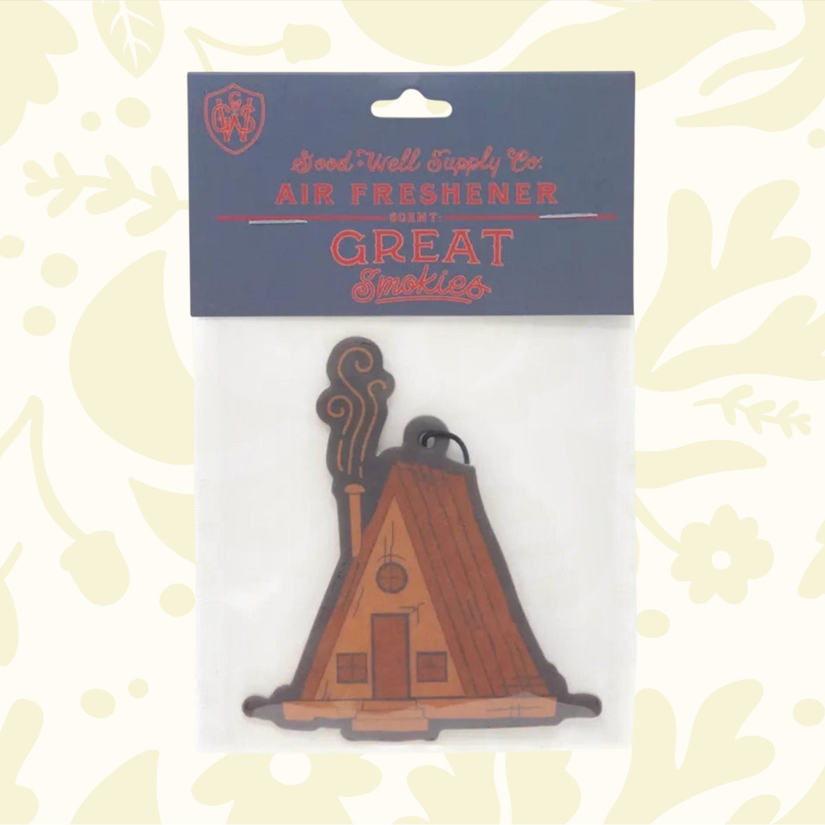 Introducing the Good & Well Supply Co Hangable Air Freshener - Great Smokies: a delightful auto fragrance designed to resemble a wooden cabin with smoke wafting from its chimney. This charming air freshener, perfect for adding a rustic touch to your car, proudly supports the National Park Foundation and is ideal for nature enthusiasts.