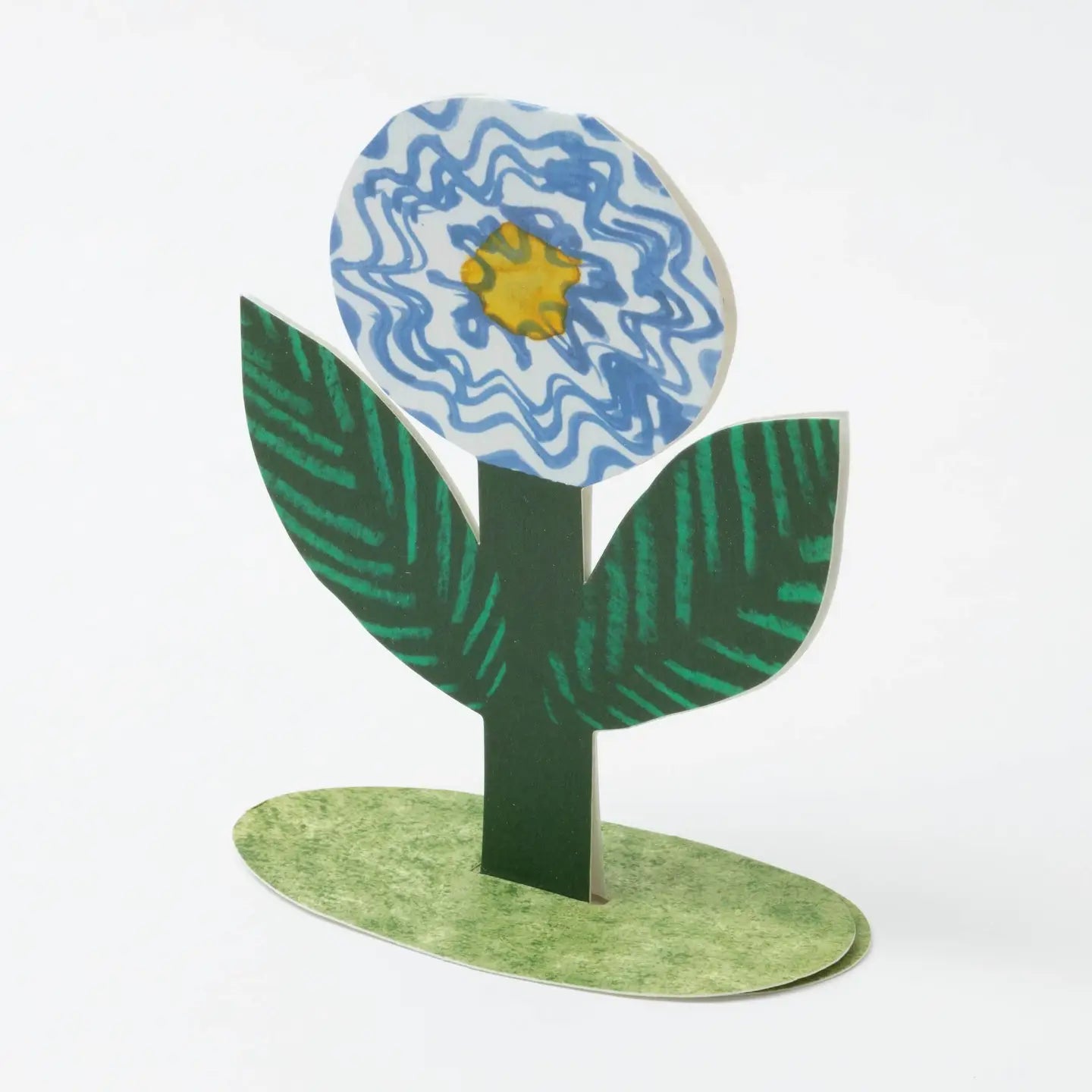 Hadley Greeting Cards Blue Flower Stand Up Card with blue and yellow flower, green leaves, and oval base - perfect for all occasions.