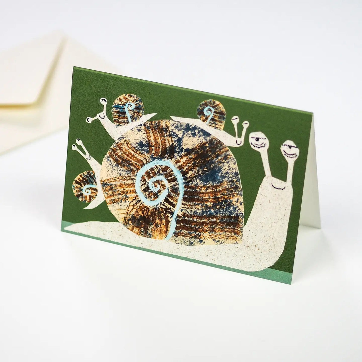 Hadley Snail Family Greeting Card: Cute big snail with three little snails on a green background. Perfect for family occasions.