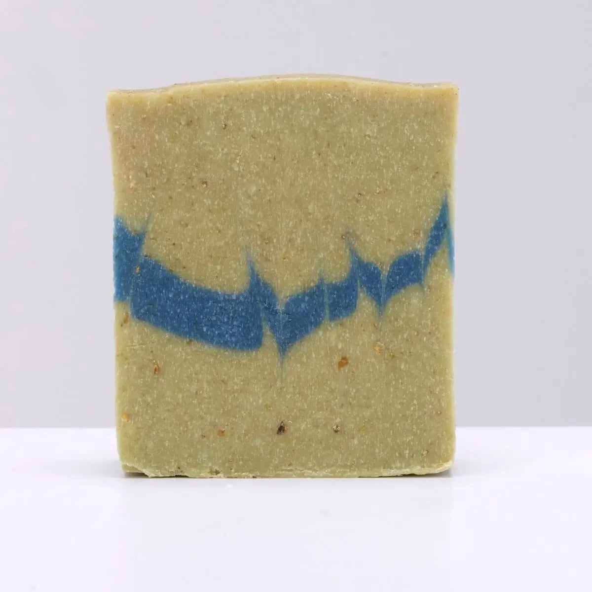 Rectangular Black Stuff Soap Bar, Dogs Bay Beach scent, olive-green with blue stripe, on plain background, natural skincare.