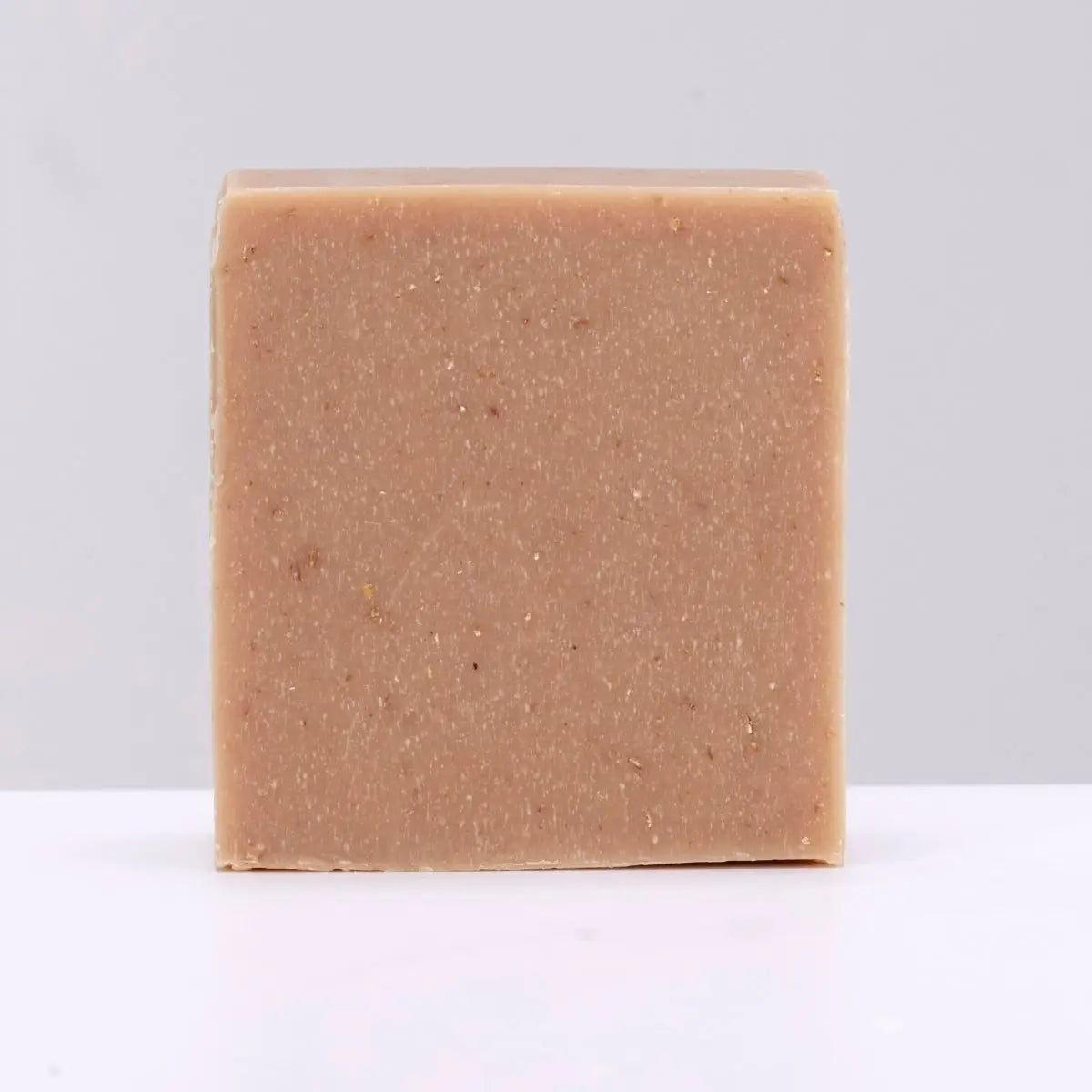 The Black Stuff Soap - Stout: beige square grooming bar by The Black Stuff, artisan skincare, on light gray background.