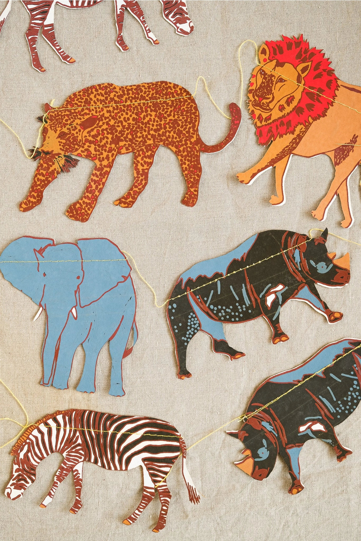 Safari Animal Garland by East End Press featuring cheetah, lion, elephant, zebra & rhino sewn on light background; nursery decor.