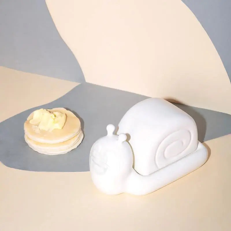 Third Drawer Down UK x Hattie Stewart snail butter dish displayed with pancakes, quirky kitchen decor on neutral background.