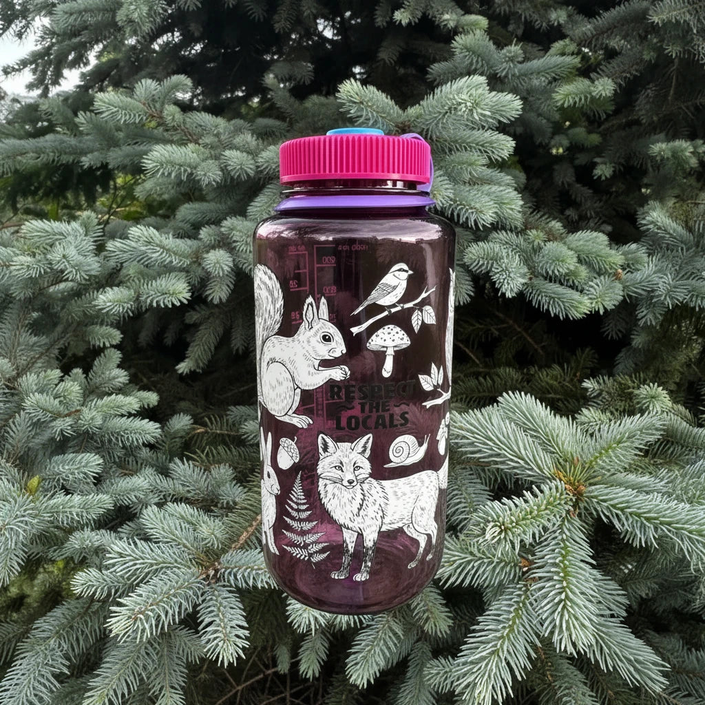 Hand holding Hey Bear Outdoors “Respect The Locals” 32oz Nalgene bottle featuring animal, plant, and mushroom illustrations.