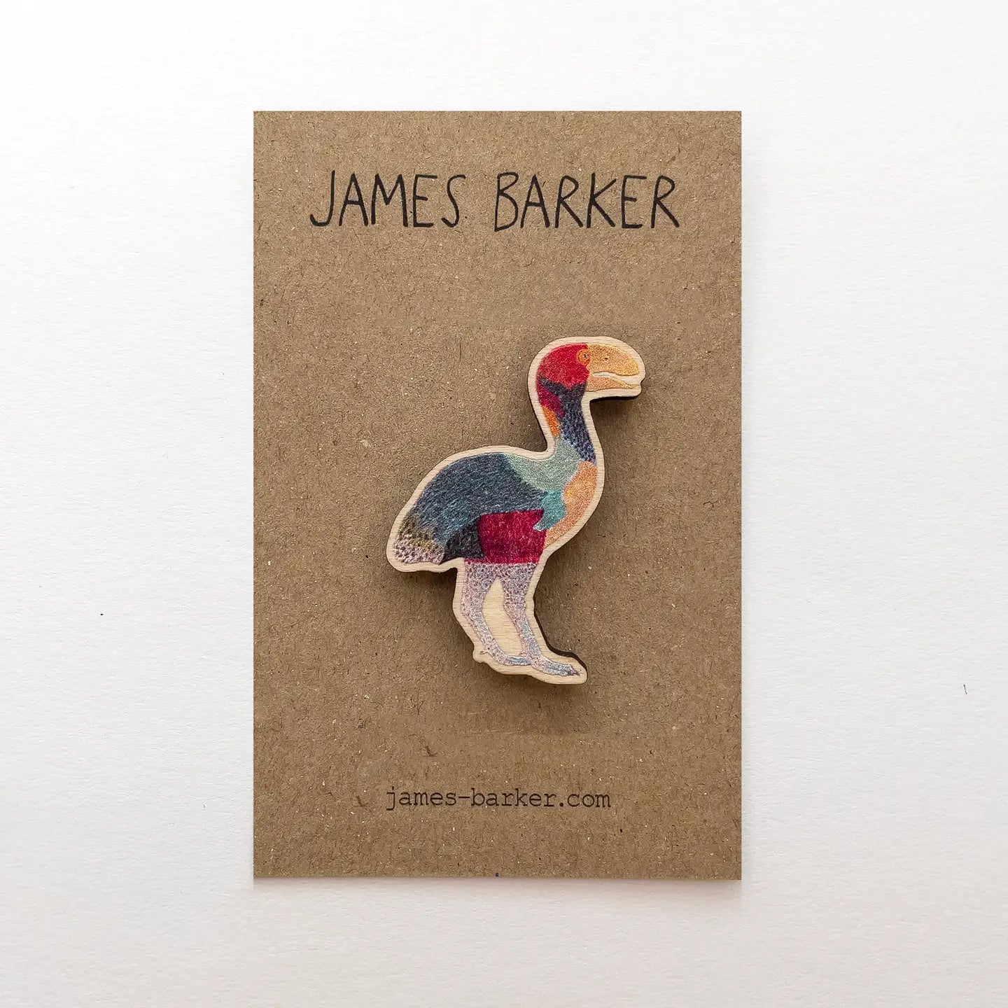 James Barker Extinct Gastornis Wooden Pin displayed on a branded brown card with James Barker website visible underneath for details.