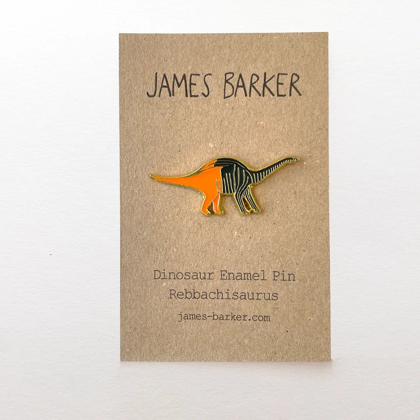 Dinosaur enamel pin: James Barker Rebbachisaurus sauropod design on collectible card—perfect gift for dinosaur enthusiasts.