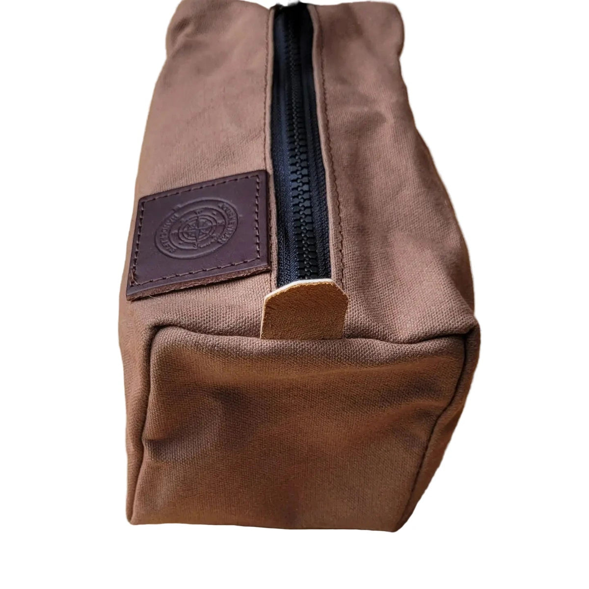 Forager Provisions LTD Journeyman Craft brown waxed canvas camping peg case with a black YKK zipper and leather patch.
