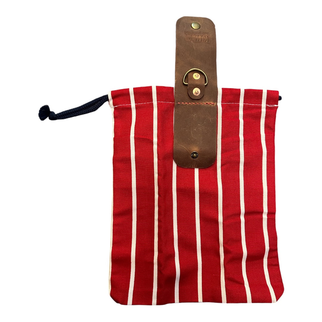 Forager Bag by Forager Provisions: red, white-striped fabric, black drawstring, brown leather strap & metal ring. Outdoor gear bag.