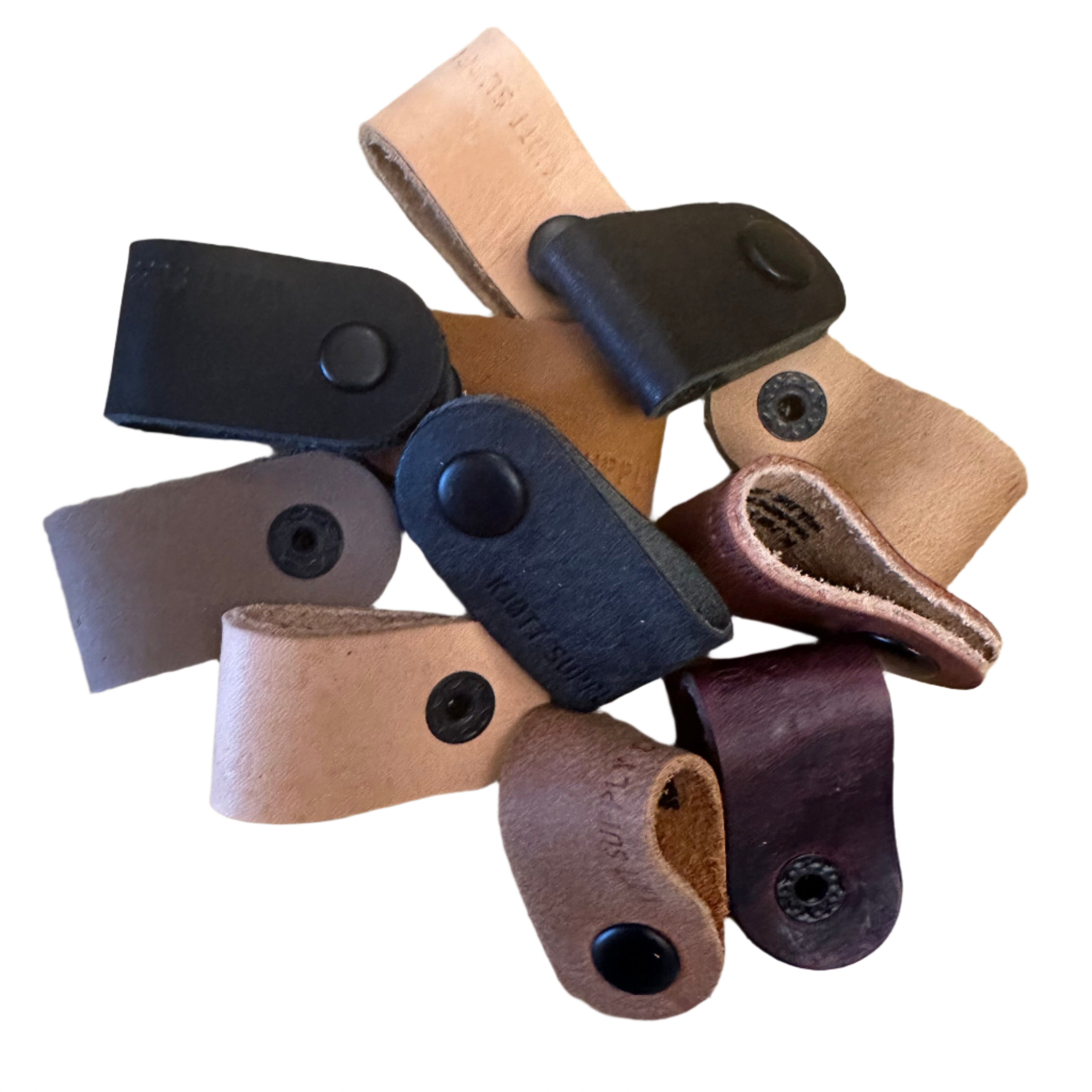 Kjøtt Supply Co Leather Cable Wraps 3 Pack—brown, tan, black—neatly arranged in a circle for cable organization.