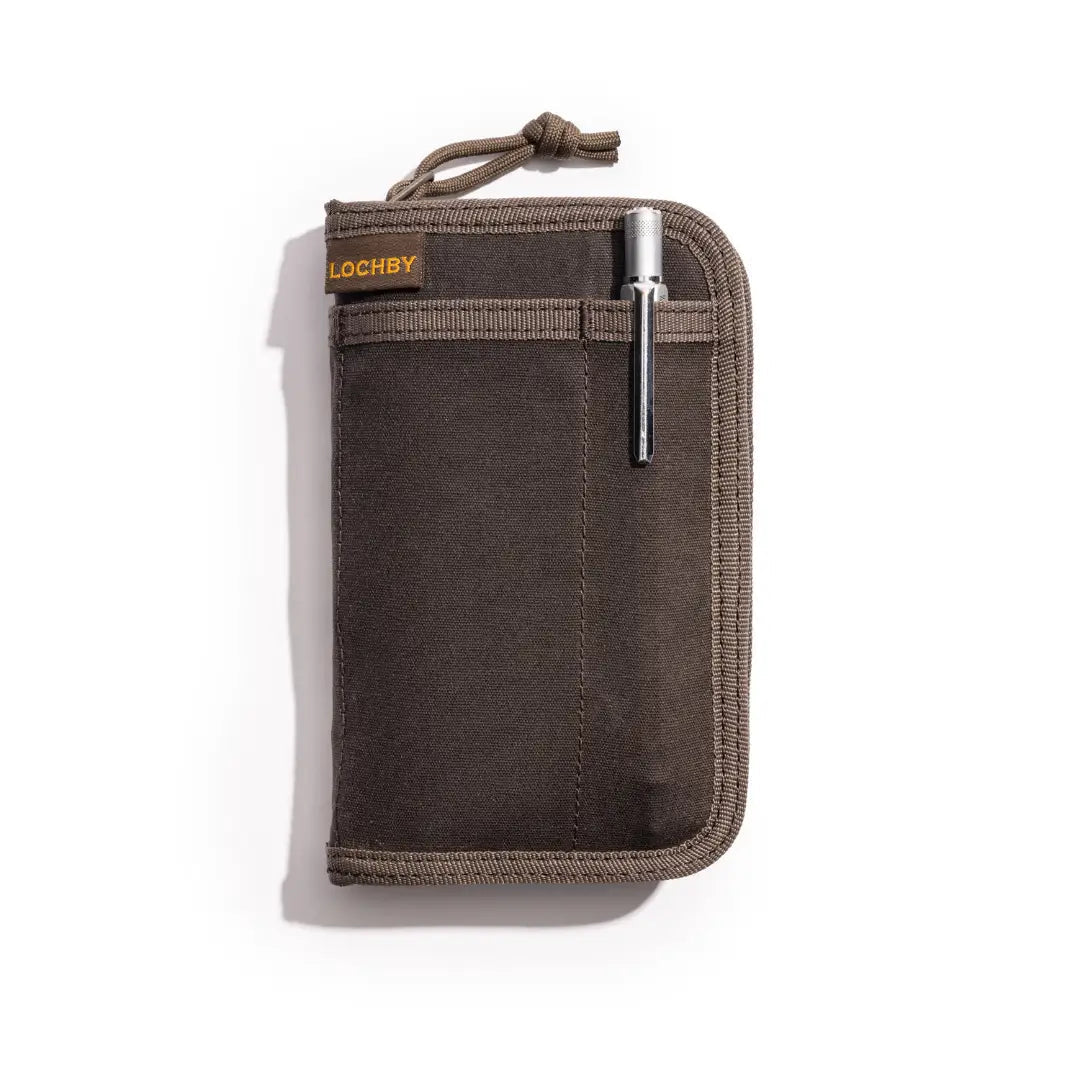 Forager Provisions LTD Lochby brown waxed canvas pocket journal with a metal pen in the exterior sleeve