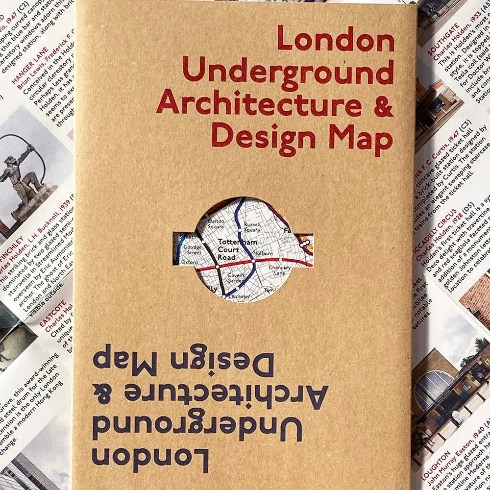 Scattered papers reveal a "Blue Crow Media London Underground Architecture Map" brochure, showcasing the transport design through a circular cutout.