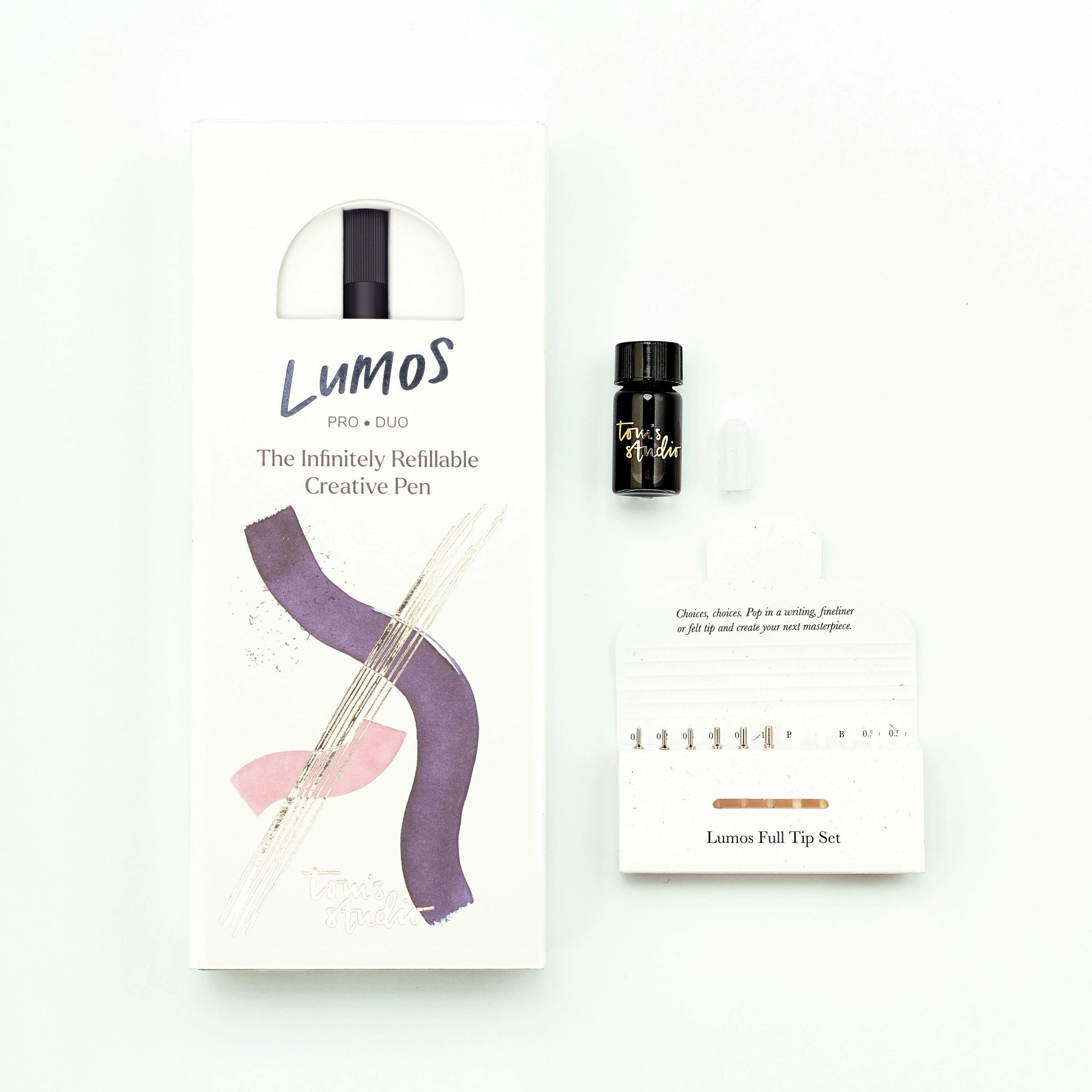 Tom’s Studio Lumos Pro Duo Black Pen set, interchangeable nibs, ink bottle, dropper & tips on white backdrop. Premium calligraphy tools.