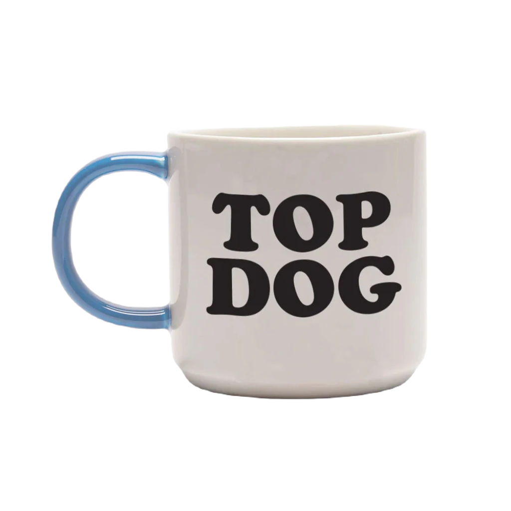 The Magpie Gifts Top Dog Snoopy Mug is a charming white mug with a blue handle, featuring Snoopy holding a trophy with Woodstock inside. In this delightful design from the beloved Peanuts series, Snoopy sports a blue ribbon. It's the perfect addition to your homewares collection.