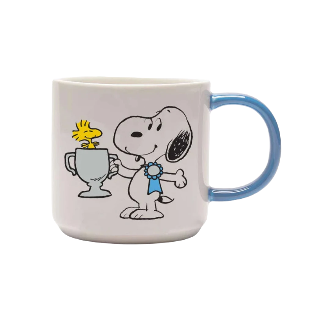 The Magpie Gifts Top Dog Snoopy Mug is a charming white mug with a blue handle, featuring Snoopy holding a trophy with Woodstock inside. In this delightful design from the beloved Peanuts series, Snoopy sports a blue ribbon. It's the perfect addition to your homewares collection.
